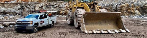 Truck In Quarry - Auto Lube Services Inc.